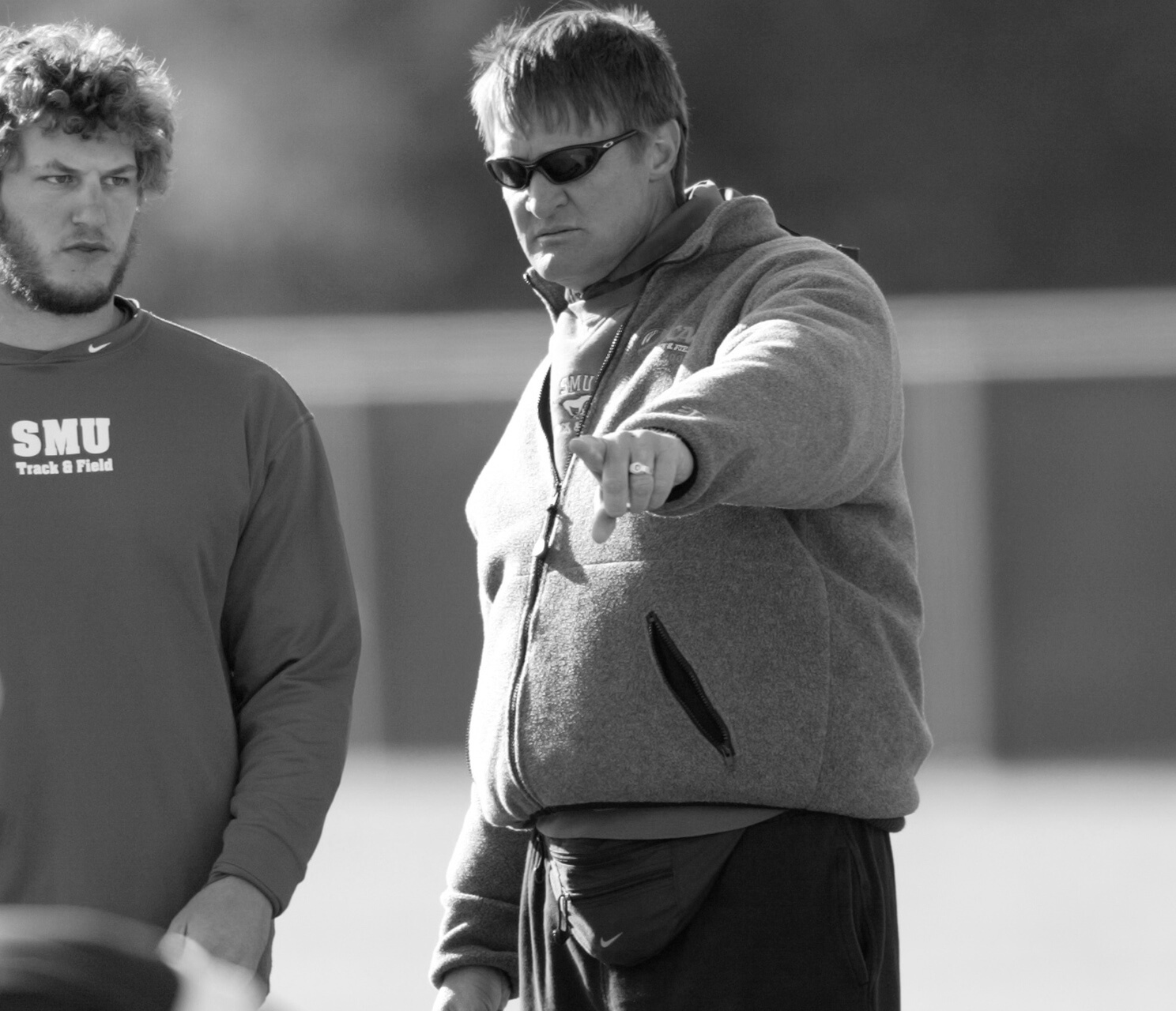 Dave Wollman coaching a thrower at SMU